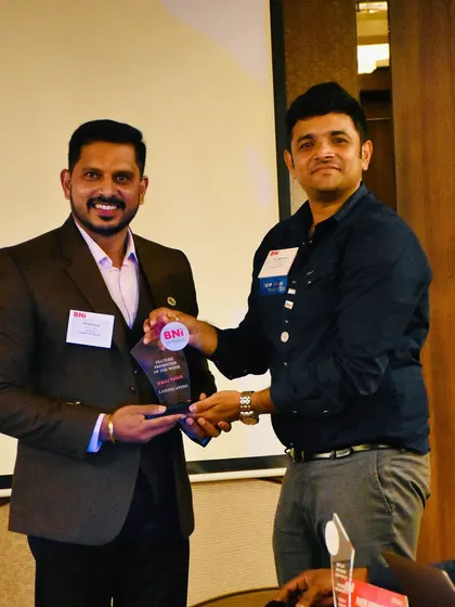 It's an honor to be recognized for our work and our contribution to the business community. Here I am receiving an award at a BNI (Business Network International) event.