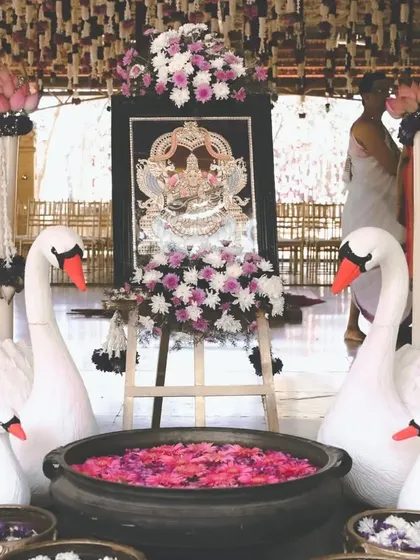 An elegant decor detail from one of our weddings. The swan figures, symbolizing purity and grace, along with bowls of floating flowers, add a touch of divine beauty to the entrance of the wedding venue.
