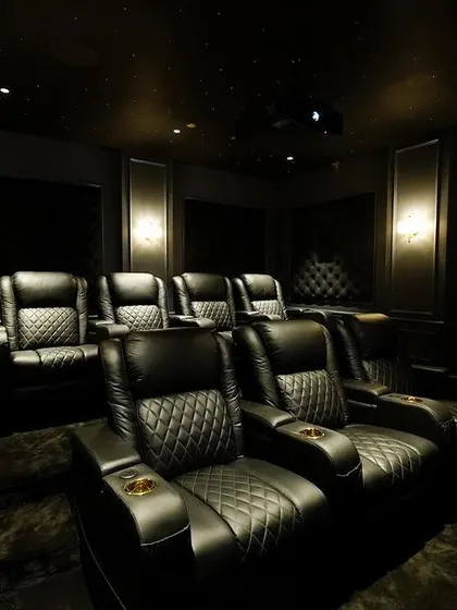 Another view of the luxurious recliners, showing the built-in cup holders and the rich texture of the leather. Every detail is considered for a premium experience.