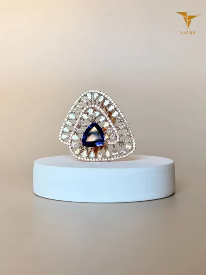 At Tiansh, I love turning shapes into statements. This ring features a striking triangular gemstone at the center, surrounded by a fan of diamonds that sparkles from every angle.
