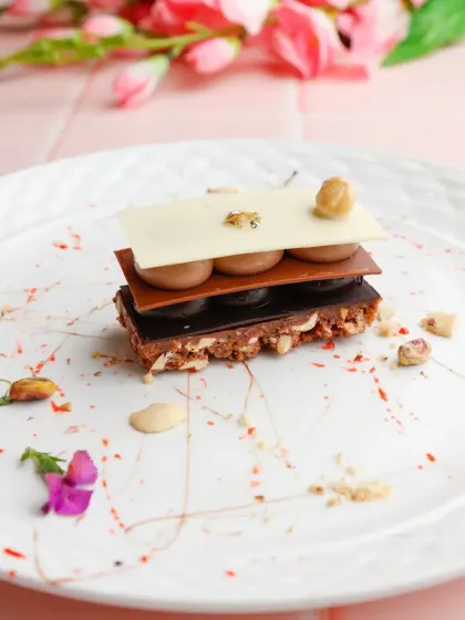 We deconstruct classic pastries to create new experiences. This Chocolate Mille-feuille features crisp layers of chocolate and pastry interspersed with creamy fillings, offering a symphony of textures in every bite.
