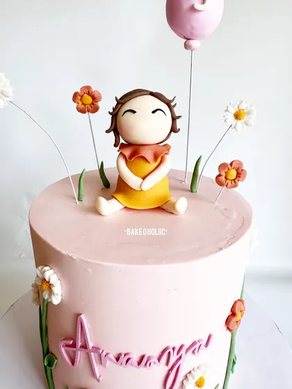 A close-up of the adorable, smiling figurine. These little toppers add so much personality to a cake.