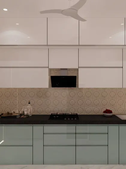 A clean and bright kitchen design featuring ivory white upper cabinets and serene blue back-painted glass on the lower units. The patterned tile backsplash adds a subtle decorative touch.