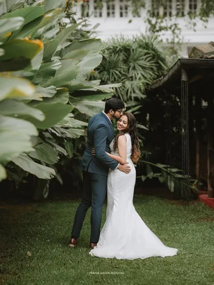 A tender embrace between Akshatha and Jeethesh in a beautiful garden. The groom's gentle kiss on her forehead is a perfect example of the soft, emotional moments I love to capture.