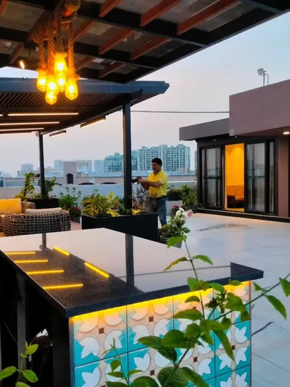 A daytime view of the completed Gurgaon rooftop, showing the bar and pergola areas.