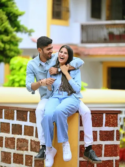 A joyful, candid moment from a pre-wedding shoot, capturing genuine laughter and connection.