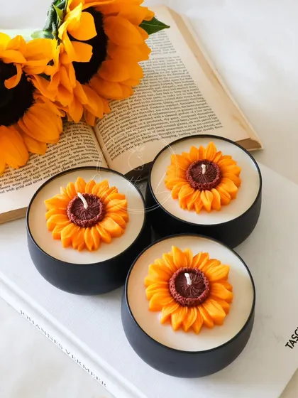 Another view of the Sunflower tin jar candles. The black tins provide a modern contrast to the rustic flower design.