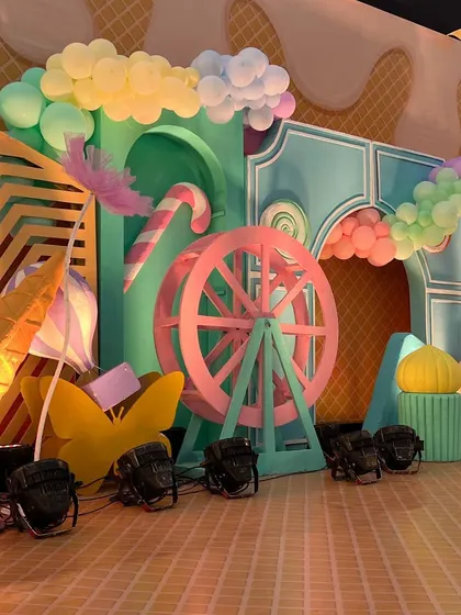 Details from the Candyland stage, including a candy cane, a ferris wheel, and balloon clouds.