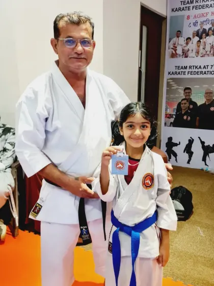 An instructor proudly stands with a young medalist. Our teaching team is dedicated to helping every student reach their full potential.