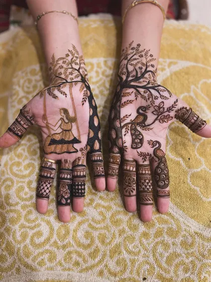 A beautiful and artistic design for a nature lover. One hand features a girl on a swing under a tree, while the other is adorned with peacocks.