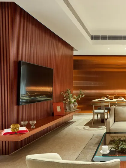 A ribbed wood-paneled wall adds texture and warmth to this living room, serving as a beautiful backdrop for the television. The open-shelf console keeps the look clean and uncluttered.