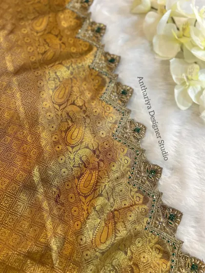 A close-up of the detailed border work on the matching saree.