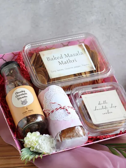Handcrafted arrangements for the special women in your life. This Women's Day hamper includes our Chunky Chocolate Granola, Baked Masala Mathri, and Double Chocolate Chip Cookies.