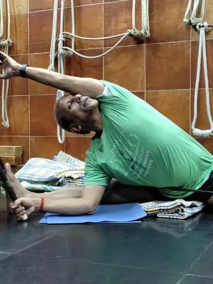 A deep side stretch using a chair, demonstrated for an online class. I teach how to use simple household items as effective yoga props.