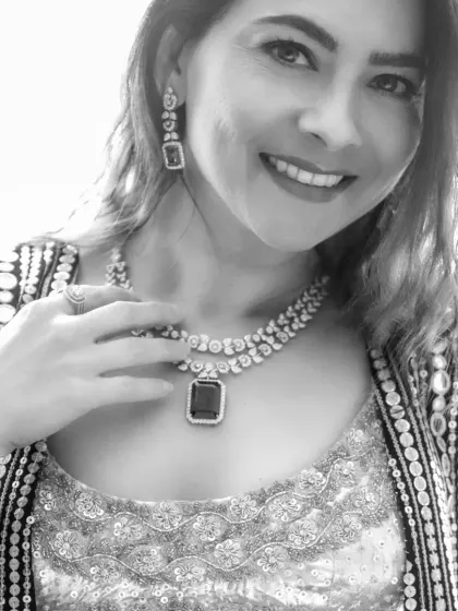 The black and white version of a smiling portrait. This edit creates a classic, timeless feel, focusing on the model's expression and the texture of her jewelry.
