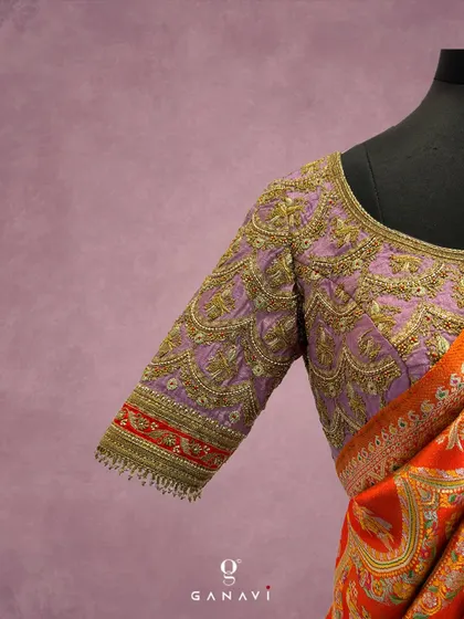 A close-up of a lavender blouse sleeve, adorned with scalloped patterns in gold zardozi work. This design is inspired by the intricate patterns found in traditional Indian jewelry, transforming the blouse into a wearable work of art.