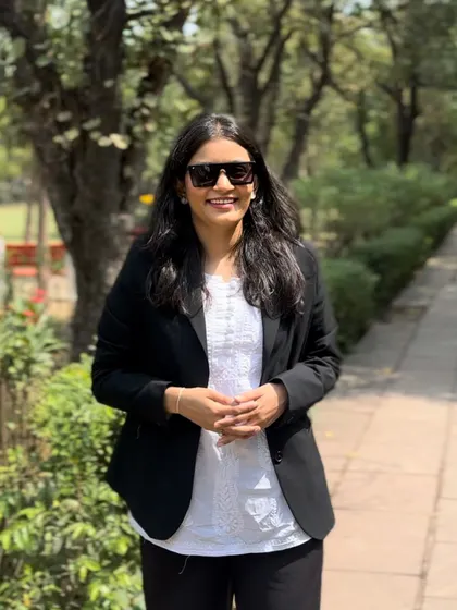 Wearing sunglasses on a bright day, but my focus on my goals is never shaded. Being a self-made lawyer means I am driven by my own ambition.