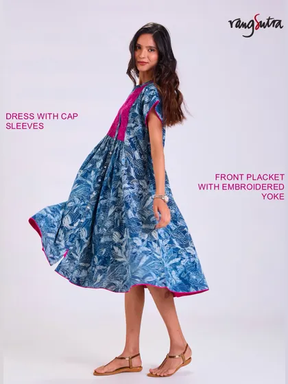 Our Chaaya dress with cap sleeves and an embroidered yoke. The flowing fabric and beautiful indigo print create a piece that moves with you and feels good all day long.