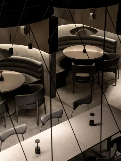 An overhead view of the dining pods at Lair, revealing the geometry of the seating arrangements. The design uses curved forms to create pockets of intimacy within the larger, open space.