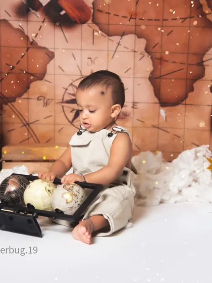 This little traveler is fascinated by the miniature globes in our vintage aviator setup.