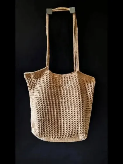The simple and elegant silhouette of our crochet jhola bag, ready to be taken on the go. We use eco-friendly yarn to create these sustainable fashion pieces.