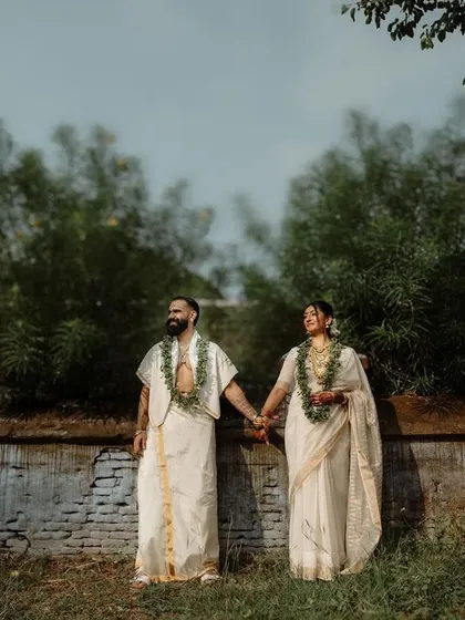 A couple in elegant white attire, standing together in a natural landscape. This photo showcases our ability to capture beautiful, minimalist portraits for intimate weddings.