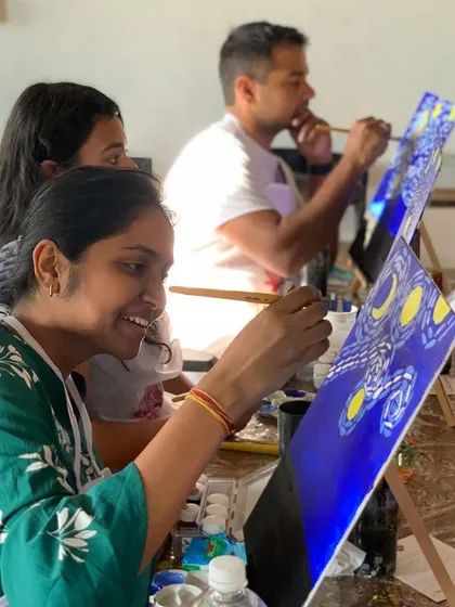 A guest enjoying a sip and paint workshop at our Bangalore studio. No experience is needed, just bring your imagination.