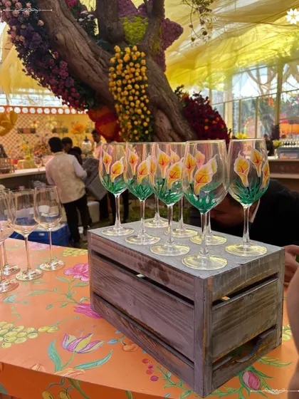 A set of custom hand-painted wine glasses for the Mehendi celebration. These bespoke details elevate the guest experience and serve as beautiful keepsakes from a unique event.