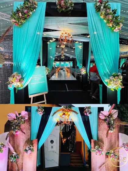 The entrance to the turquoise-themed reception, featuring beautiful drapes and floral arrangements.