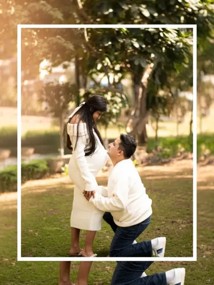 A romantic proposal-style pose during an outdoor maternity shoot. The father-to-be kneels before his partner, creating a touching and memorable photograph.