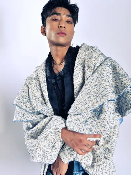 A detailed shot to show the unique tweed-like fabric of the coat. Editorial work is often about highlighting these small but important details.
