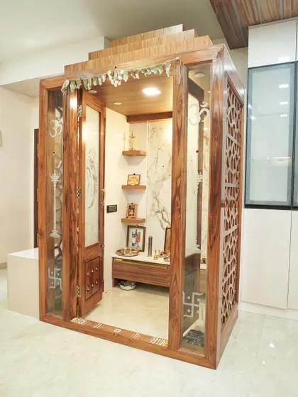 We designed this standalone traditional pooja mandir as a serene sanctuary within the home. The intricate wooden craftsmanship, detailed jali work, and dedicated lighting create a peaceful and divine space for prayer and reflection.