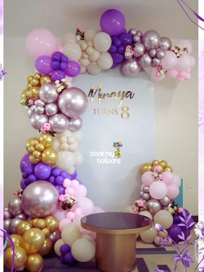 This elegant purple and gold theme was designed for Vinaya's 8th birthday, but its sophisticated style is perfect for any age. The beautiful balloon arrangement with floral accents creates a luxurious and celebratory feel.