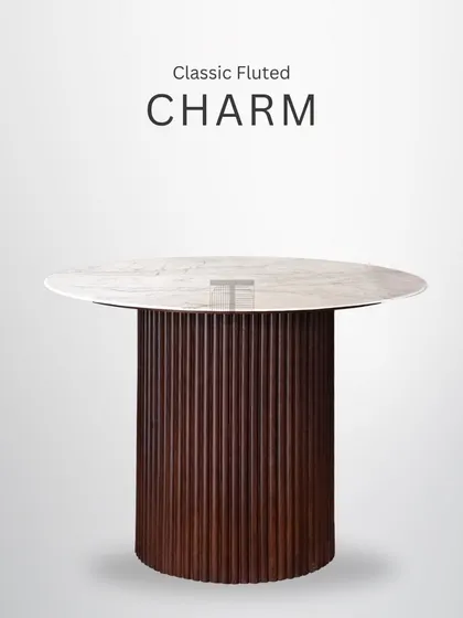 This round dining table with a fluted base is a piece of classic charm. It's perfect for intimate gatherings and serves as a stunning centerpiece for any dining space.