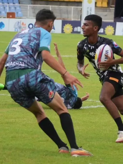 A tense moment in a rugby match. The sport teaches players how to handle pressure and work together as a team to overcome challenges.