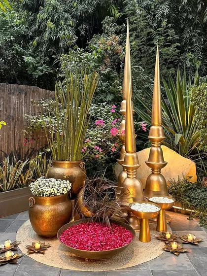 Another angle of the brass decor corner, showing the variety of pots and plants used.