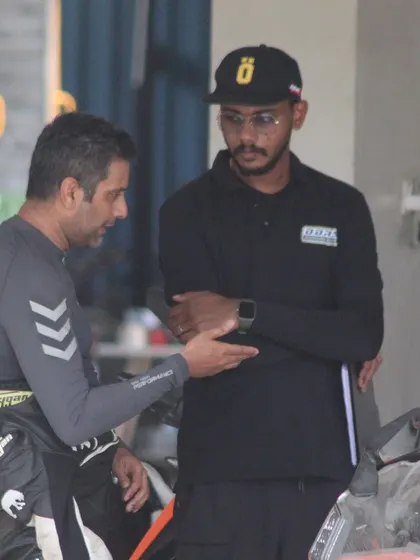 An instructor provides feedback to a rider between sessions. This continuous loop of practice and analysis is how skills are built.