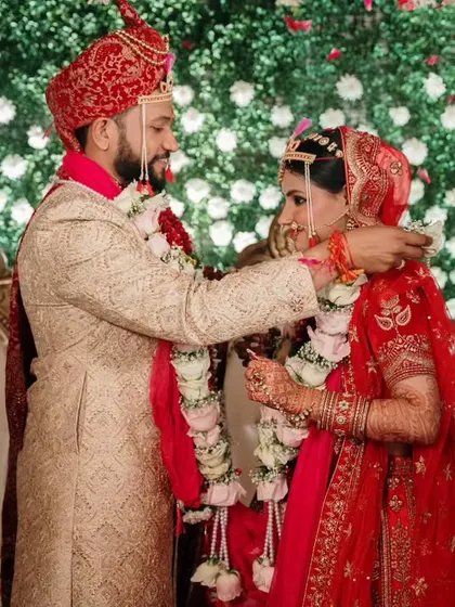 The Varmala ceremony, a symbol of mutual acceptance. We capture this pivotal moment against a stunning floral backdrop, highlighting the couple's first ritual as partners.