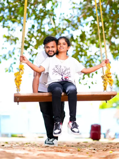 A fun and casual pre-wedding photo on a park swing. These simple, happy moments often make the best memories.