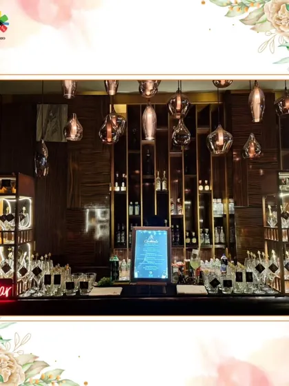 A sleek, modern bar setup featuring warm wood tones, elegant pendant lighting, and a well-organized back bar. This design is perfect for sophisticated corporate events or intimate celebrations.