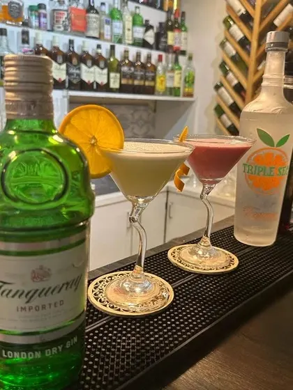 A pair of gin cocktails, showcasing different styles and garnishes. We can create a diverse gin menu for your event.