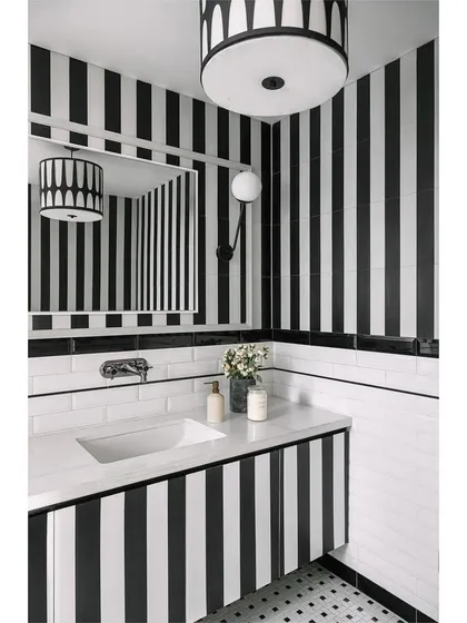 The media lounge powder room is a captivating blend of personality and style. We used bold black and white stripes to create a dramatic yet cozy space, proving that bathrooms can tell a story.