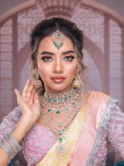 A close-up of a model from my masterclass, showing how the soft, curly open hairstyle frames the face and complements the heavy jewelry.