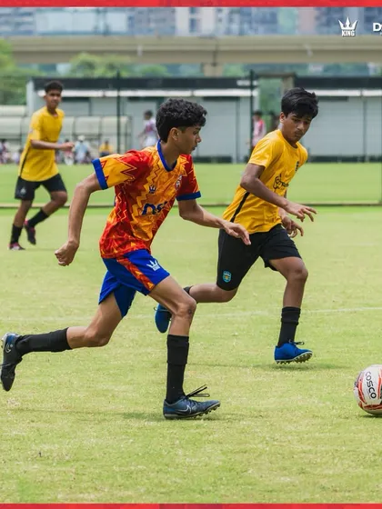 A player shields the ball during a competitive drill. We train for real match situations.