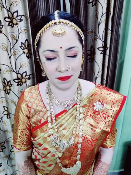 A close-up of Jaylakshmi's Varapooja makeup. I used soft, shimmery eyeshadows and a classic red lip to create a timeless bridal look that enhances her natural beauty.