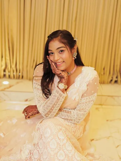 A client looking sweet and elegant in a white chikankari style lehenga.
