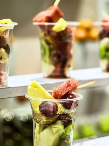Mixed fruit cups with pineapple, watermelon, and grapes. A colourful and refreshing treat that's easy for guests to enjoy while mingling.