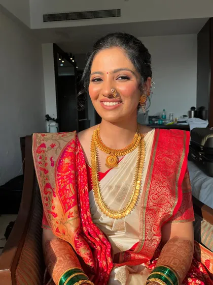 A beautiful fusion look for a bride celebrating both Gujarati and Marathi traditions. We kept the makeup minimal with coral and brown tones to complement her unique saree drape, which combined two styles.