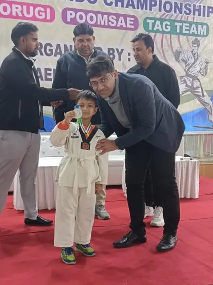 A proud moment for this little fighter as he receives his medal at the taekwondo championship held at Karnail Singh Stadium.
