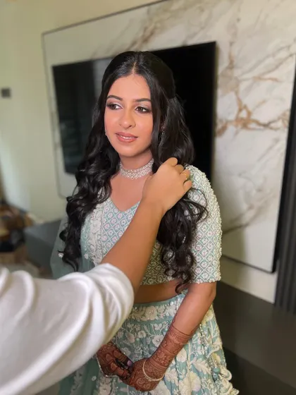 A behind the scenes shot of Twisha getting her hair styled. Her makeup is already looking flawless.